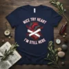 Nice Try Heart I'm Still Here quote t-shirt with a graphic of a bandaged anatomical heart and red lightning bolts