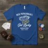 Blue t-shirt featuring "NICK PAPAGIORGIO'S Get Lucky GAMBLING SCHOOL YUMA, AZ - EST. 1997" text with dice, casino chip, and
