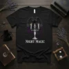 Black t-shirt with "NIGHT MAGIC" text, a bat-winged black cat, candelabra, and purple roses