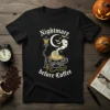 Black t-shirt with "Nightmare before Coffee" text, featuring a spooky coffee cup, moon, bats, and a vintage lamp post design