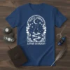 Night's Embrace Lunar Guardian text with a mystical cat silhouette looking at the moon on a dark blue t-shirt