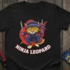 NINJA LEOPARD t-shirt design featuring a cartoon leopard in ninja attire holding swords, with red accents