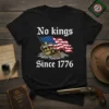 Black t-shirt with "No kings Since 1776" text, an American flag, and two crowns on stones