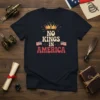 No Kings In America text with crown and US flags graphic on a navy t-shirt