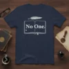 Navy blue t-shirt with "No One." text inside an open book graphic and a feather on top