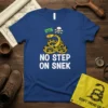 Blue t-shirt with "1776 NO STEP ON SNEK" text, featuring a coiled yellow snake and skull graphic, representing American patriotism
