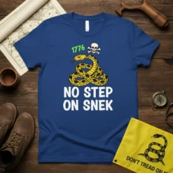 Blue t-shirt with "1776 NO STEP ON SNEK" text, featuring a coiled yellow snake and skull graphic, representing American patriotism