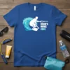 Blue t-shirt with white graphic of a wakeboarder in a wave, text reads NOAH'S WAKE ZONE