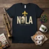 Navy blue t-shirt featuring "NOLA NEW ORLEANS" text with a gold fleur de lis and city skyline graphic