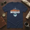 Navy blue t-shirt with the word NOMAD in white, featuring a desert landscape, compass, and a person riding a motorcycle