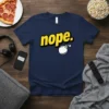 Navy blue t-shirt with yellow "nope." text and a white cartoon bomb graphic, featuring the primary keyword Nope Bomb T-Shirt
