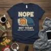 Grumpy orange cat in bed with text "NOPE NOT TODAY AND STILL NOT TOMORROW" on a navy t-shirt