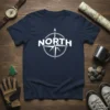 Navy t-shirt with a white circular compass design and the word NORTH above the compass points