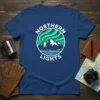 Northern Lights t-shirt design featuring aurora borealis, snow-capped mountains, and a city skyline over water