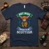 Not Irish Proud to Be Scottish t-shirt with a cute Highland cow graphic and Scottish thistle accents
