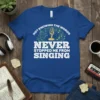Graphic tee with text "Not Knowing The Words Never Stopped Me From Singing" featuring a microphone and musical notes