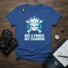 Blue t-shirt with "NOT A PRINCE NOT CHARMING" text and a skull graphic wearing a crown and crossed bones