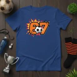 Number 67 soccer graphic with a soccer ball and explosive orange and yellow background on a blue t-shirt