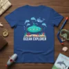 Ocean Explorer T-Shirt with a teal submarine, dolphins, and coral reef graphic