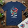 Ocean Gem Freshwater Beauty text with a colorful Betta fish illustration on a navy blue t-shirt