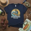 Ocean Rider Cruising t-shirt design with a cool turtle surfing a wave, wearing sunglasses and a cap
