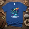 OCEAN'S CALL FREEDOM AWAITS text with a colorful jumping whale graphic on a blue t-shirt