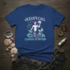 Ocean's Call Guardian of The Deep t-shirt with a purple-haired mermaid holding a shell, surrounded by waves