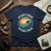 Ocean's Roar Untamed Power t-shirt with a bold graphic of a crashing wave under a bright sun, circular border