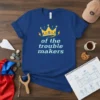Of the trouble makers quote with a crown graphic on a royal blue t-shirt