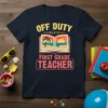 Off Duty Beach First Grade Teacher t-shirt with an open book showing a beach scene