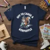 Navy t-shirt with a squirrel wearing a party hat riding a scooter, with the text "off to cause a kerfuffle"