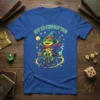 Off to Commit Tom frog wizard design on a blue t-shirt, showing a frog in a wizard hat riding a