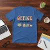 Office Manager text in retro font with computer, pen, papers, and coffee cup icons on a blue t-shirt