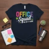 Office Squad We Get It Done text design with colorful letters and office icons on a navy t-shirt