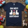 "Oh Hey! 4 Birthday" text with two llamas and a cake graphic on a navy blue t-shirt, designed for a