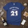 Blue t-shirt with white text "OH MY GOD she's 21" and festive graphics for a 21st birthday celebration