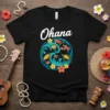 Black t-shirt with "Ohana" text and a circular design of sea turtles, waves, and tropical flowers