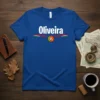 Blue t-shirt with "Oliveira" in white text, featuring Portuguese flag colors and emblem, perfect for Portuguese heritage celebration
