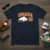 Navy blue t-shirt with white buffalo graphic and orange 'OMAHA 18' text, representing Omaha pride