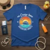 T-shirt featuring "on Cruise time ADVENTURE awaits" text with a cruise ship, ocean waves, and sunset graphic