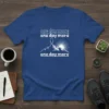 Royal blue t-shirt with white text "one day more" repeated and a graphic of a hiker on a mountain peak