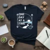 One Day At A Time text on a navy blue t-shirt with a circular graphic of a sunrise over mountains