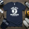 One Hit Wonders Volleyball 2021 text with a volleyball player graphic on a navy t-shirt