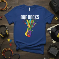 Blue t-shirt with "ONE ROCKS" text and a colorful electric guitar graphic exploding with music notes and shapes