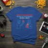 Blue t-shirt with red and blue text "ONE OF THE BROTHERS RECORDS THE OTHER BROTHER HAVING A SNACK" and a