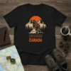 Ontario Canada t-shirt design featuring a bear on a mountain peak with trees and a sunset, text reads Ontario Canada