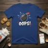 Oops! bomb graphic with text on a navy blue t-shirt, representing a funny baking or kitchen mishap