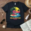 Oranjestad Aruba text with tropical beach scene, palm trees, ocean, and fish graphic on a dark t-shirt