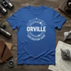 Orville Exploration Crew text with circular starburst and planet graphic on a blue t-shirt