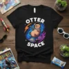 Black t-shirt with "OTTER SPACE" text and a cute cartoon otter wearing an astronaut helmet and holding a ray gun